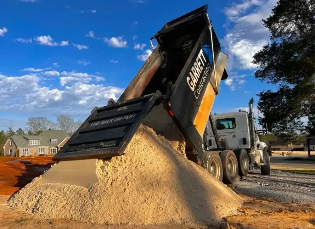 Dump truck delivering gravel.