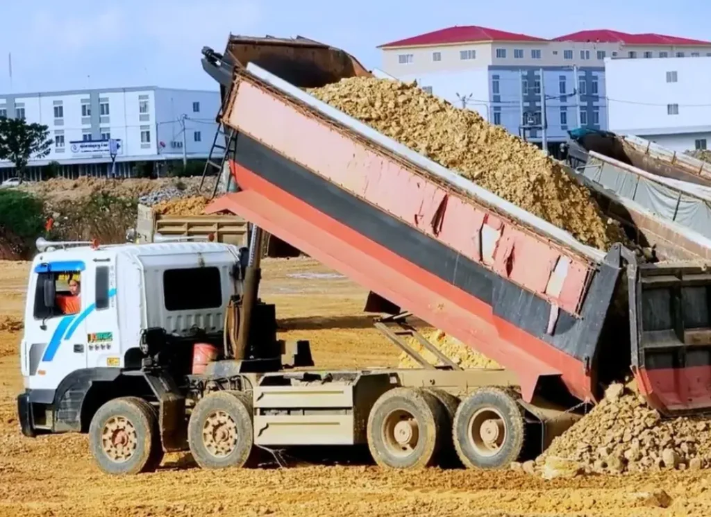 Dump truck delivering gravel.
